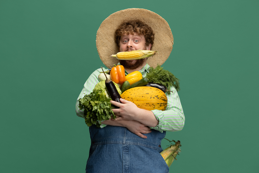 redheaded bearded man farmer with vegetables harvest isolated green studio wall 1